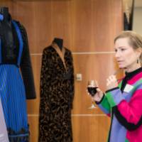 Guests looking at costumes on display.
